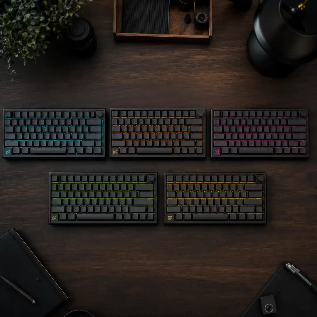 Five mechanical keyboards arranged on a dark desk representing the five DaVinci Resolve keyboard layout presets.