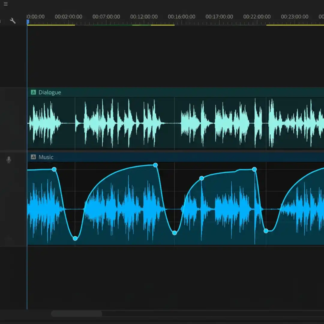 Music track with auto-ducking volume keyframes dipping under a dialogue track in Premiere Pro